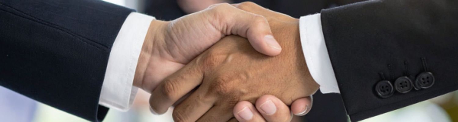 two people in suits shaking hands