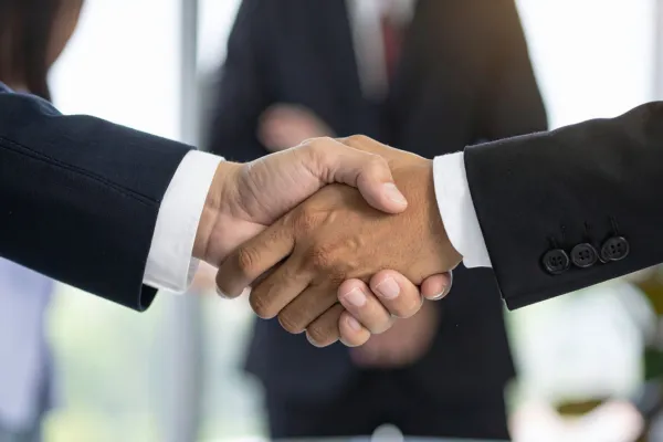 two people in suits shaking hands