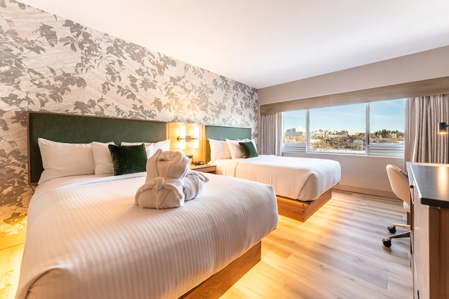 Park Town hotel room with two queen beds, a work desk, and a large window overlooking the surrounding area.